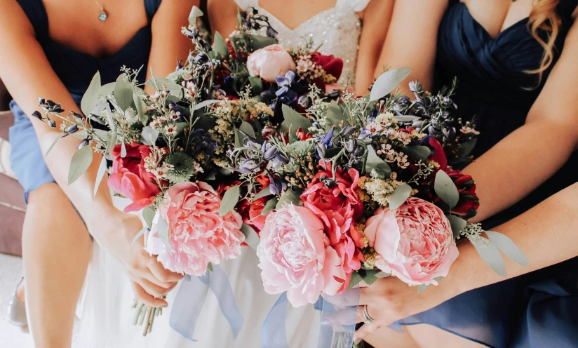 a bride holds her bridal bouquet of pink flowers