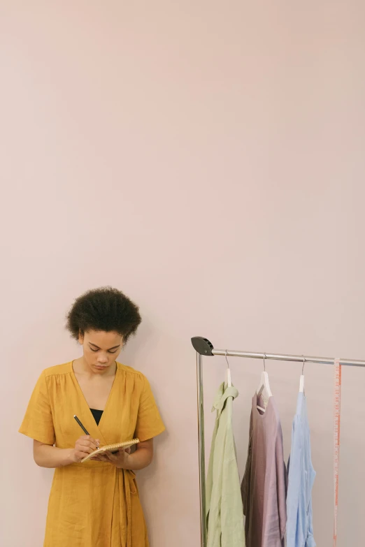 a woman stands in front of an assortment of towels