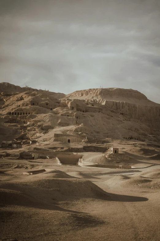 a hill in the desert has a desert village in it