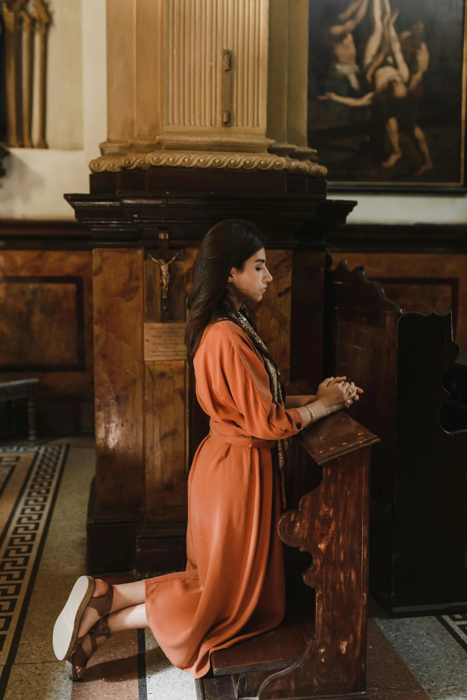 a woman sits at a table and writes