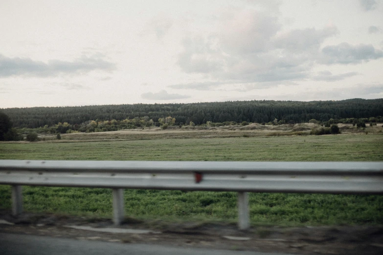 view from inside of a car looking at mountains, land and trees