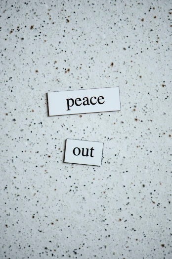 two pieces of paper that say peace and out