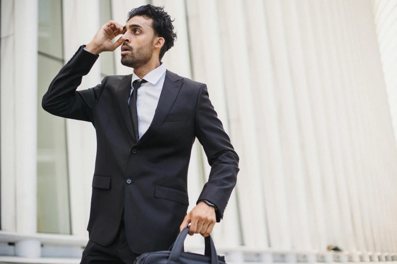 a businessman walking down the street with a black bag