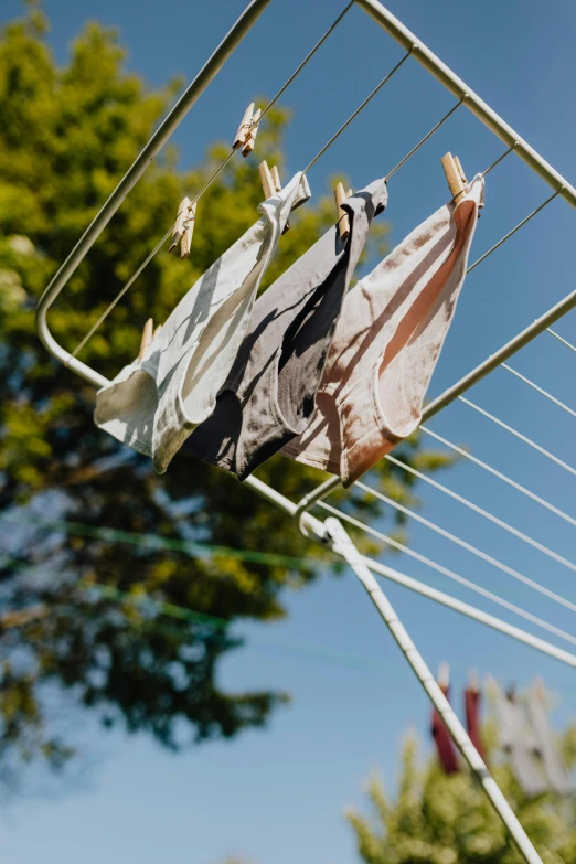 clothes drying on an electric line outside in the sun