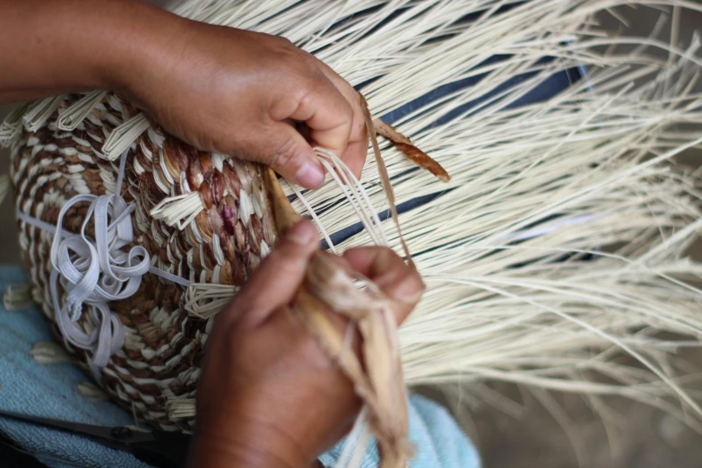 a person using a weaving machine on an item