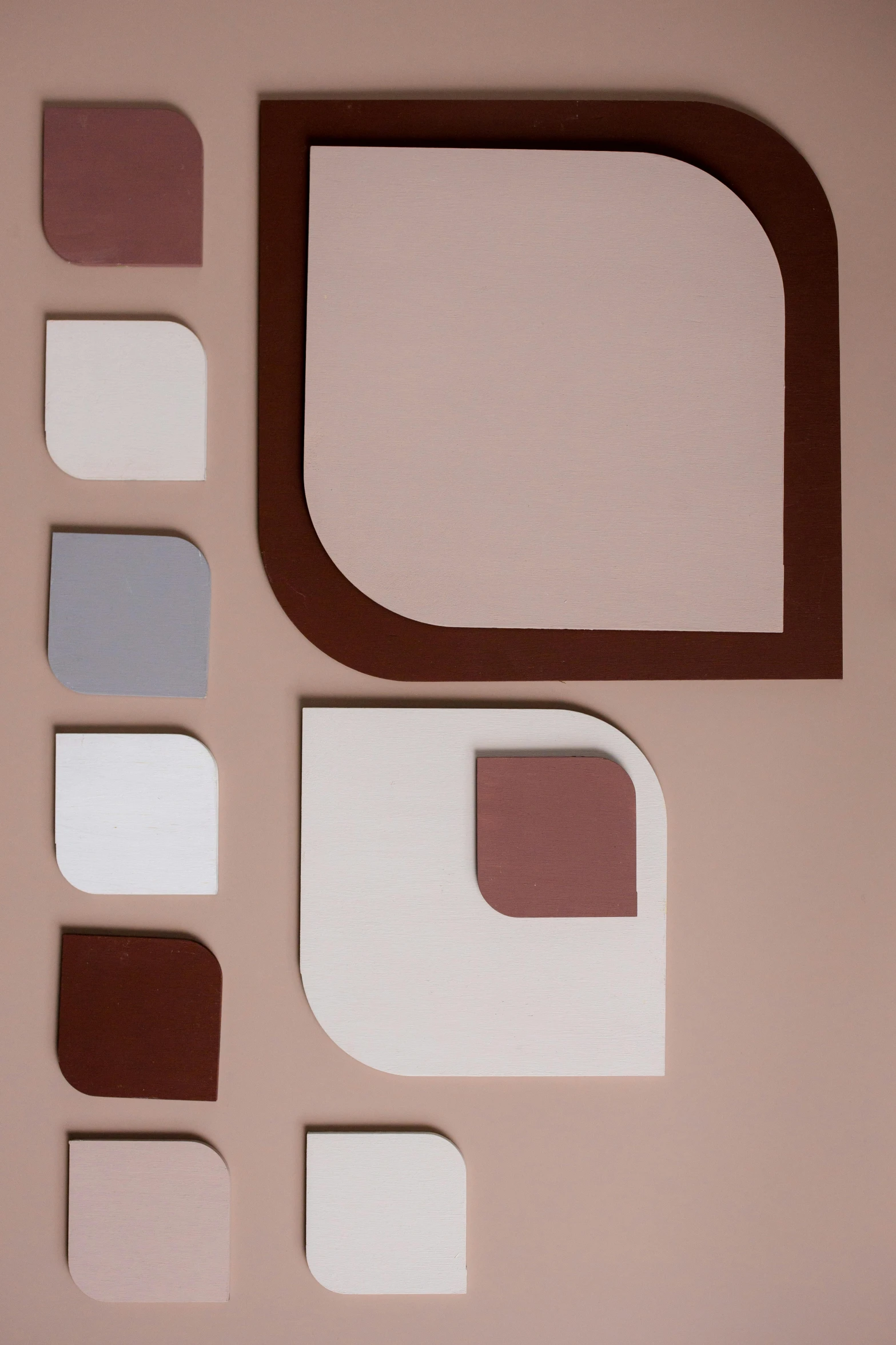 various cut - out shapes on a plain pink surface