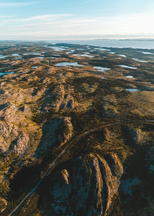 the view from above of a rocky area, with land in front of it