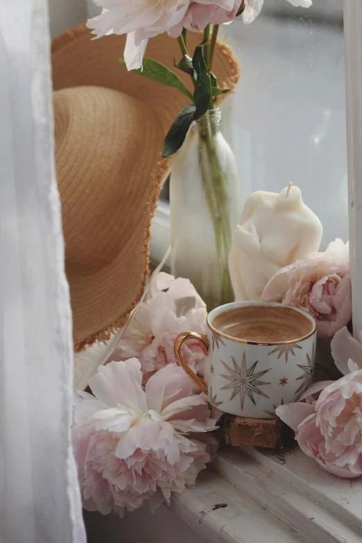 a cup and saucer filled with water on a windowsill