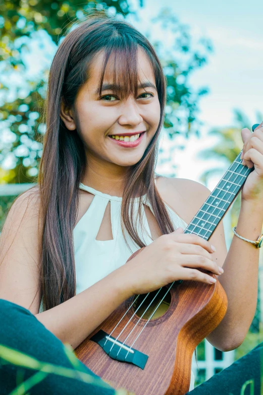 a girl is holding an instrument in her hand