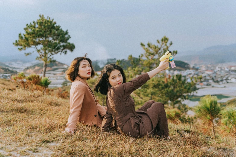 two women on a hill with a toy