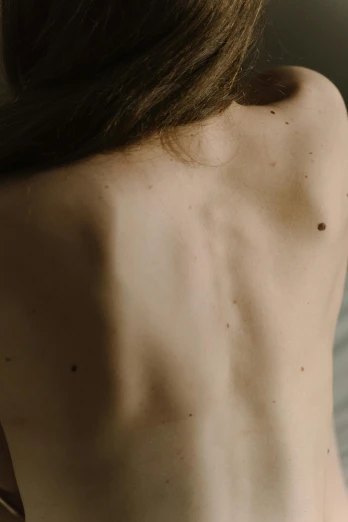 the back of a womans shoulder while wearing a neck tie