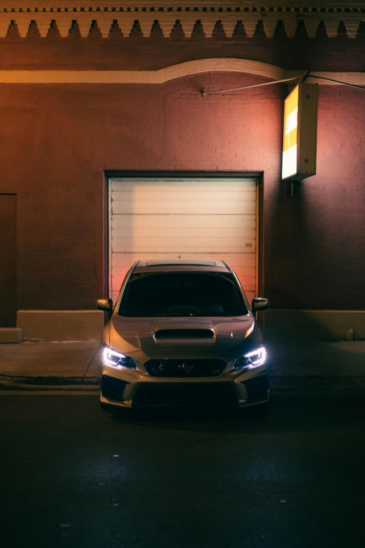 a car parked next to a garage on a street