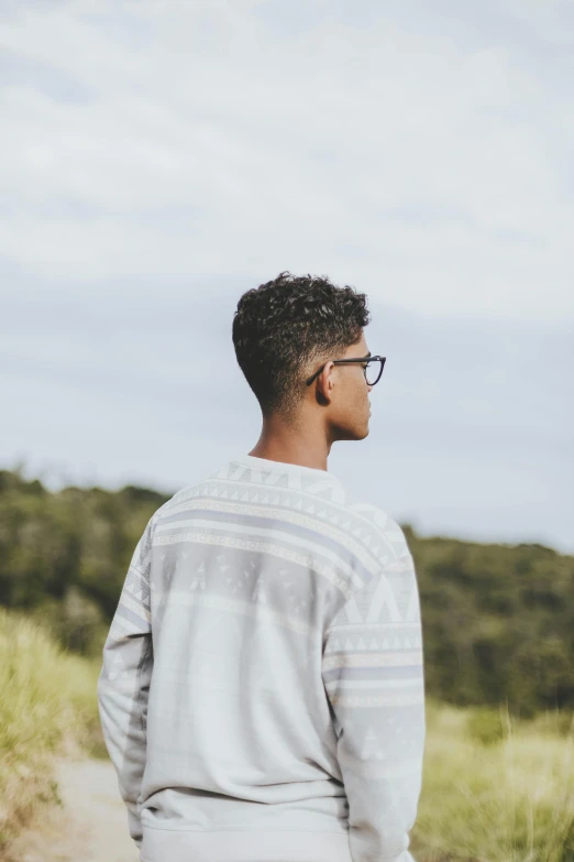 man in glasses standing outside on a dirt path