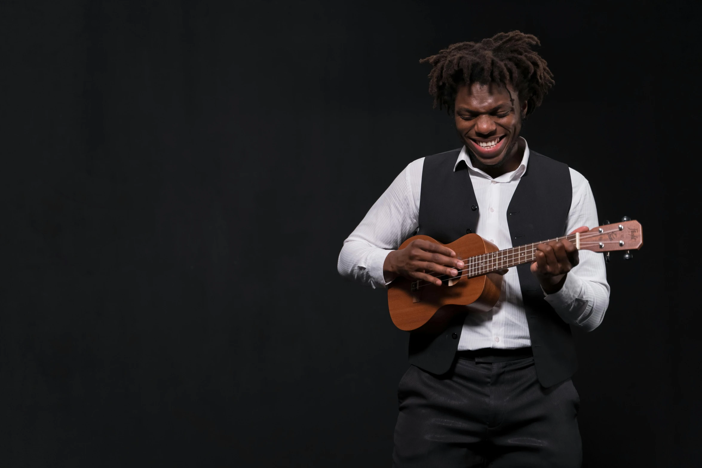 a man in white shirt holding a guitar