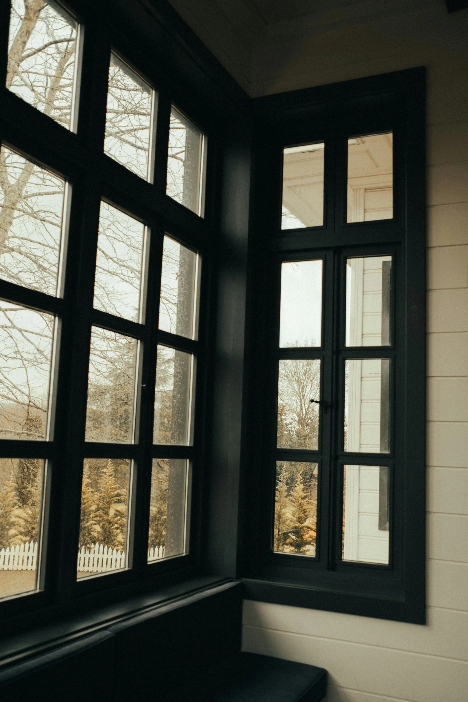 a window and a bench on the porch of a house