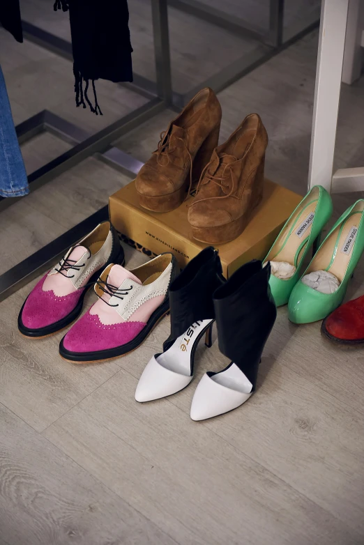 seven pairs of colorful flats are sitting on top of a shelf