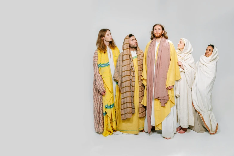 five people standing in a row wearing religious outfits