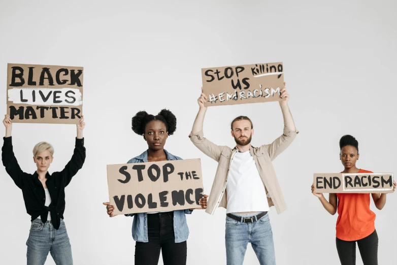 some people holding signs that say stop the violence