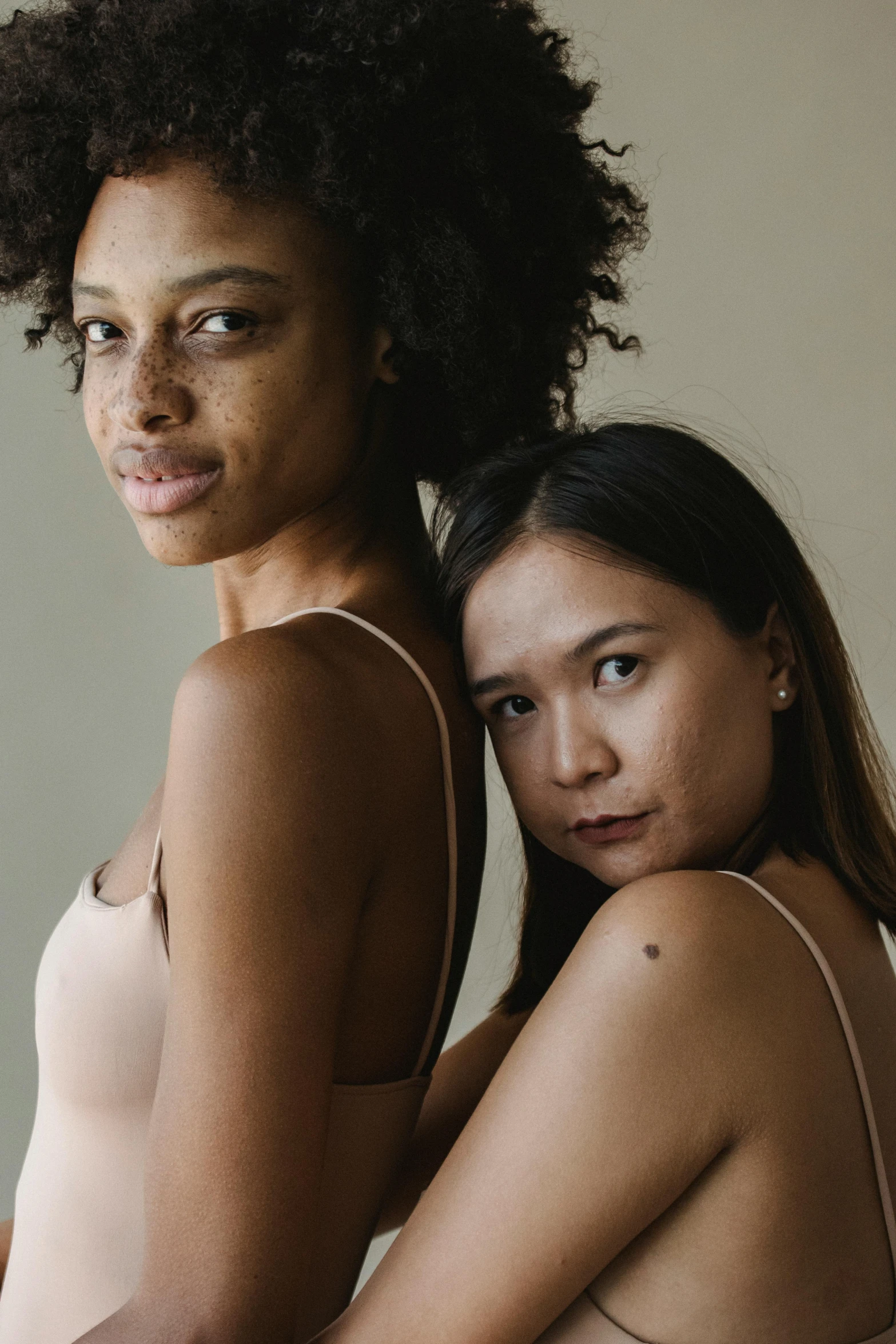 two women are posed to pose for the camera