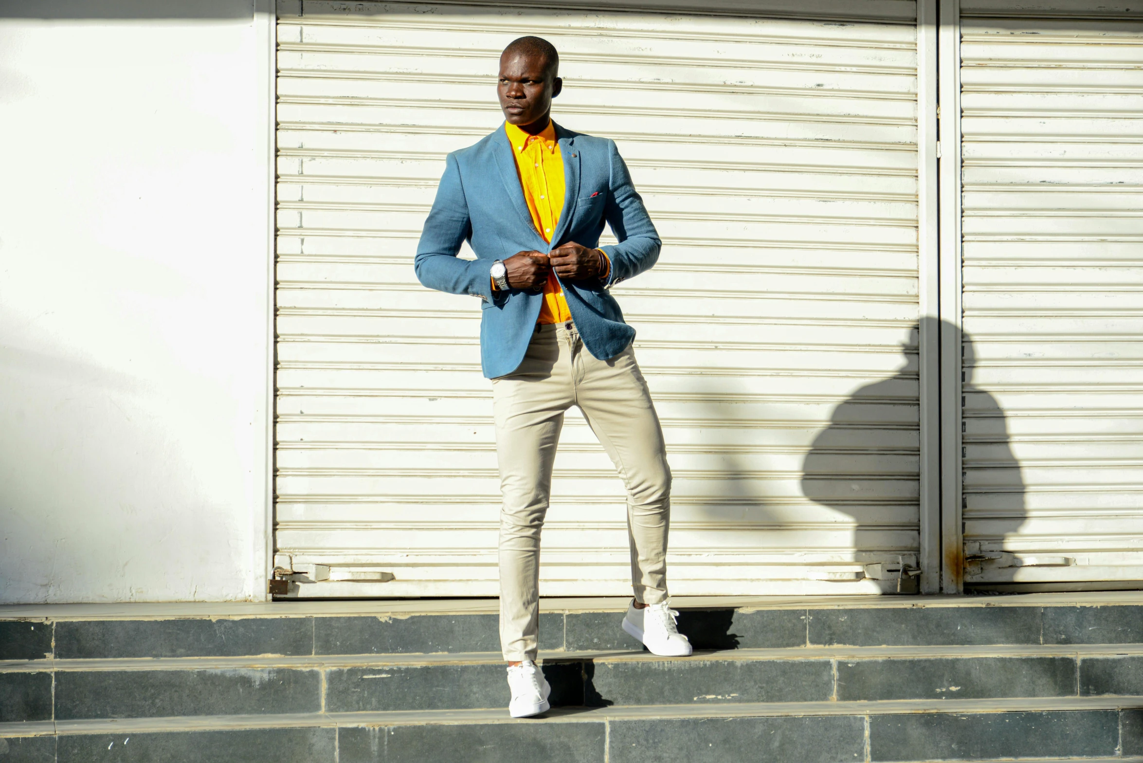 a man in a blue jacket and yellow shirt