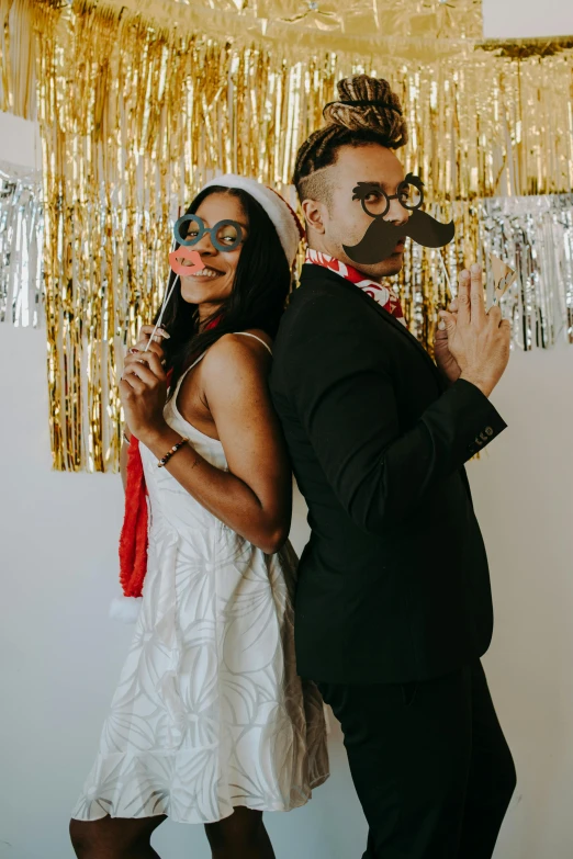 a man and woman dressed up like the bride and groom pose with a fake moustache on their face