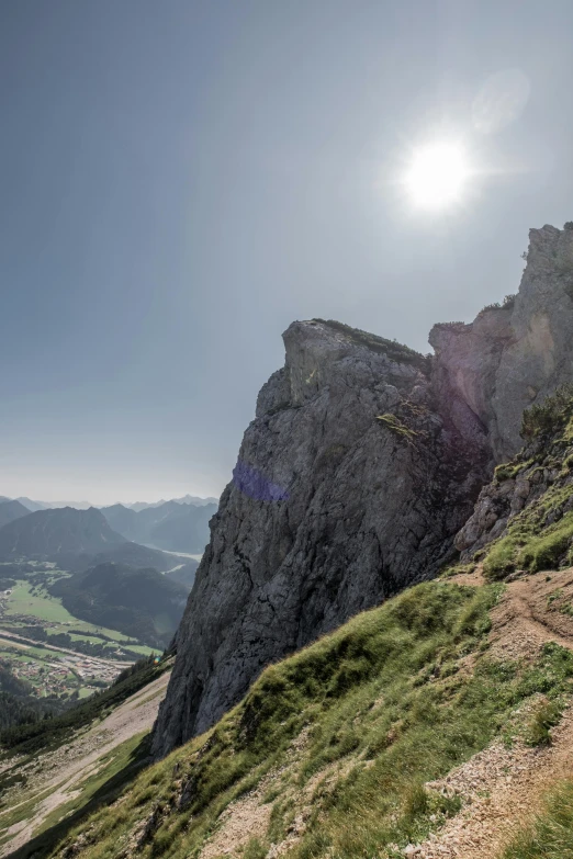 sun shining over a rocky hill in the mountains