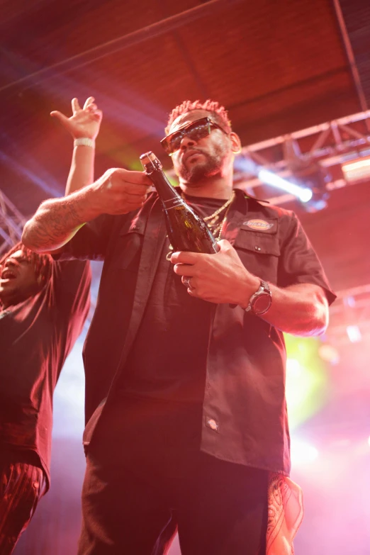 an african american man is holding up his microphone