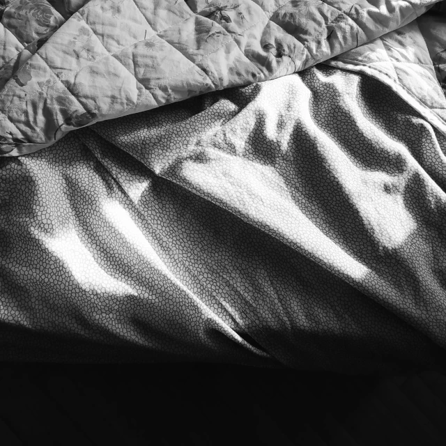 the comforter covers are neatly folded on the bed