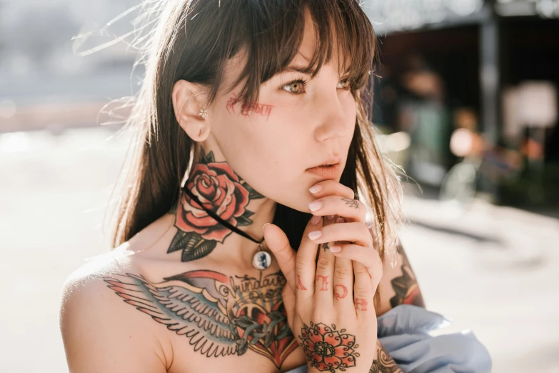 a woman with tattoos on her neck and hands