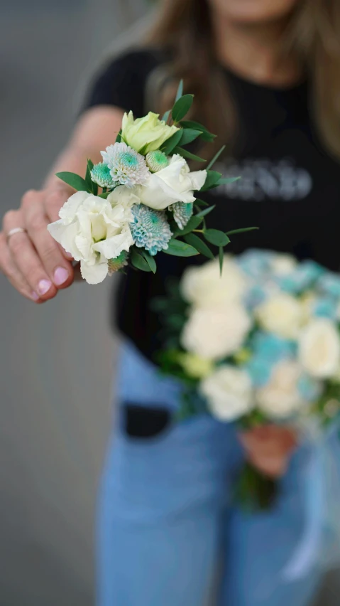 two girls are holding different colored flowers