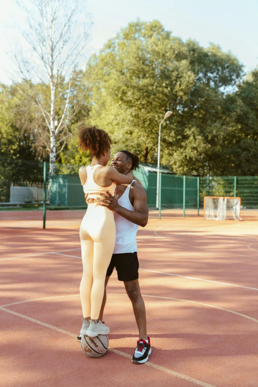 the man and woman are emcing on the court