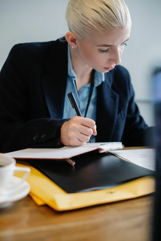 a woman at a desk with a notebook