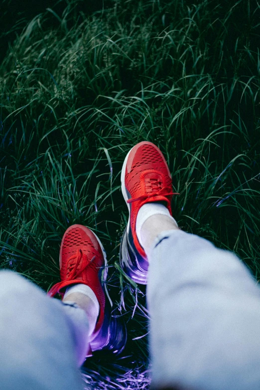 someone's feet resting in the grass by itself