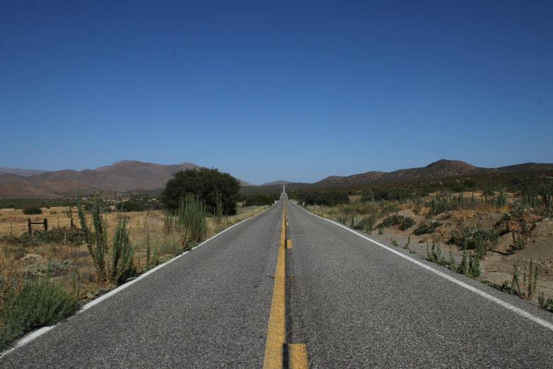 a deserted road is on the middle of the desert