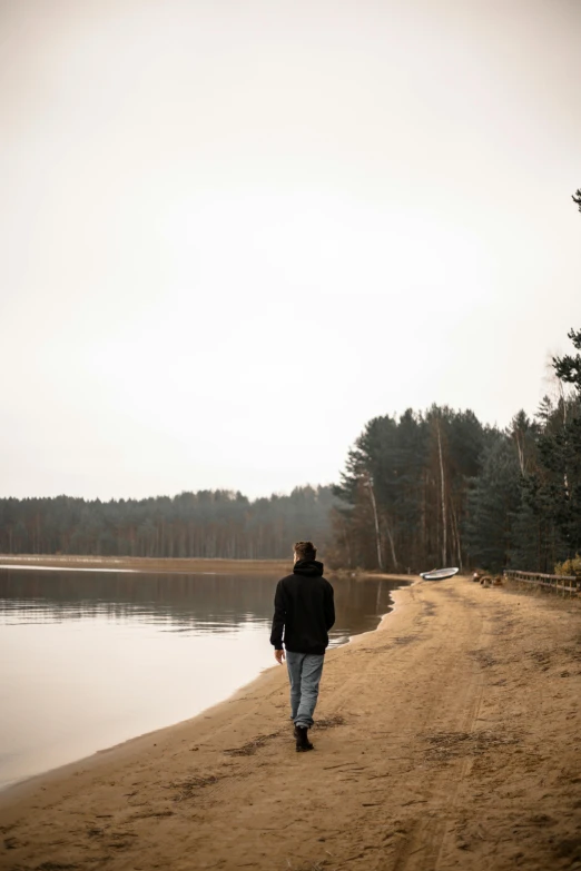 a person walking along a beach near water