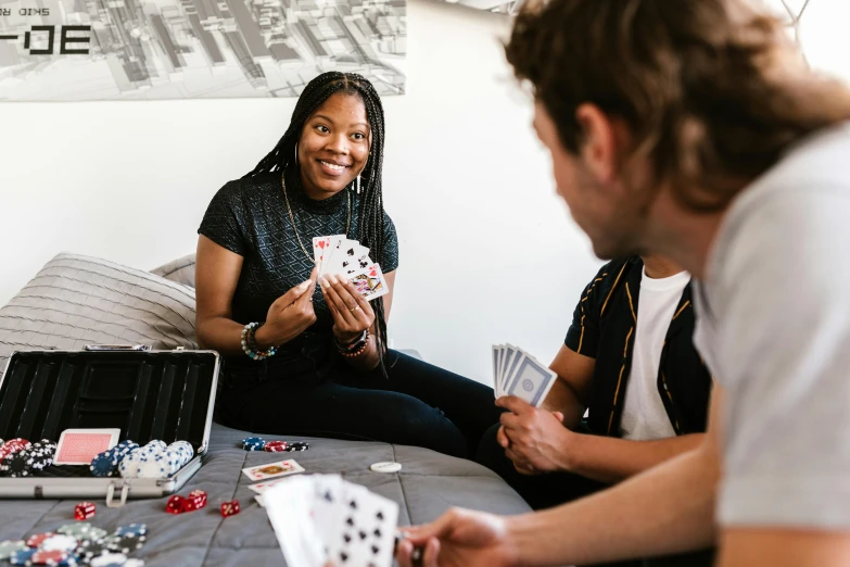 a woman is playing a card game at a living room