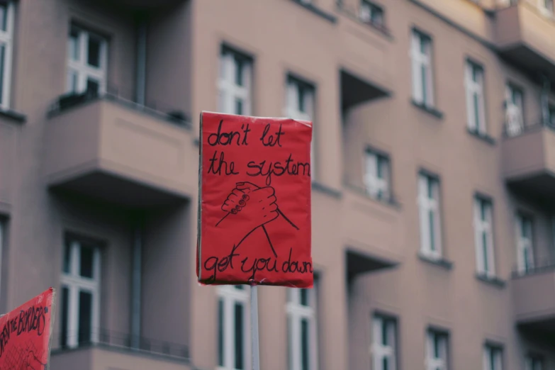 a building with a red sign attached to the outside of it