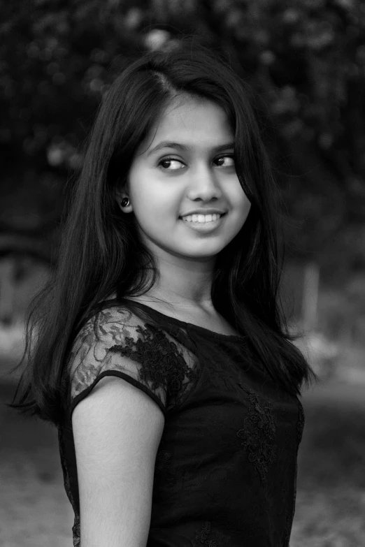 a  poses in a black dress