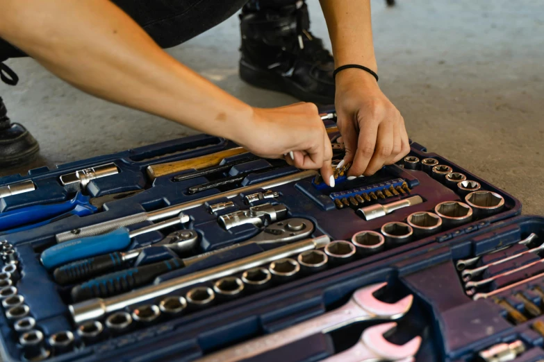 mechanic working in the garage in front of his tool kit