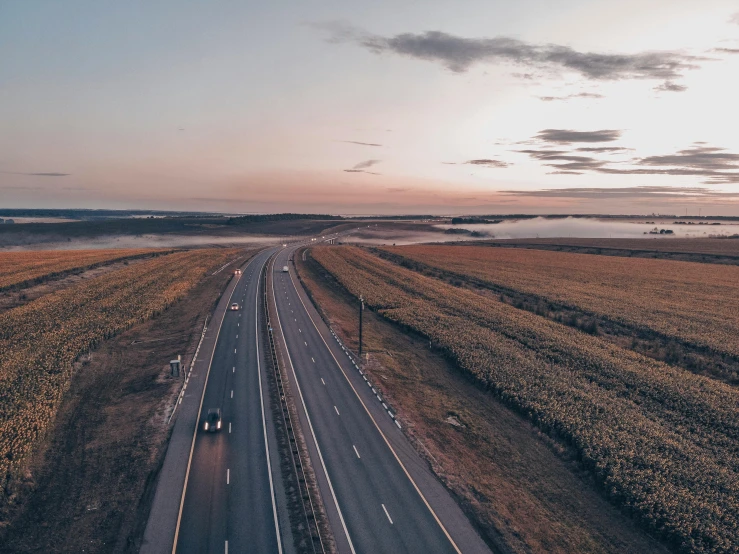 a road with lots of lanes and some cars on one side