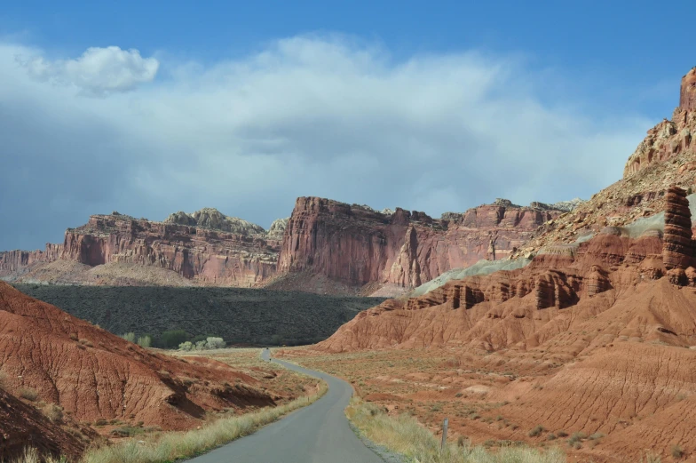 a curved mountain road curves through an arid terrain