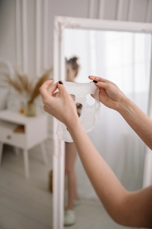 a young woman holding soing and placing on it