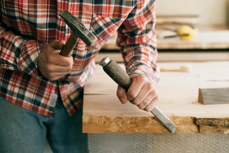 a person working on wood with an electric hammer