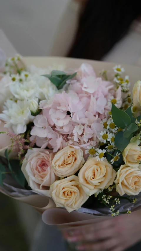 someone holding a bouquet of flowers in their hand