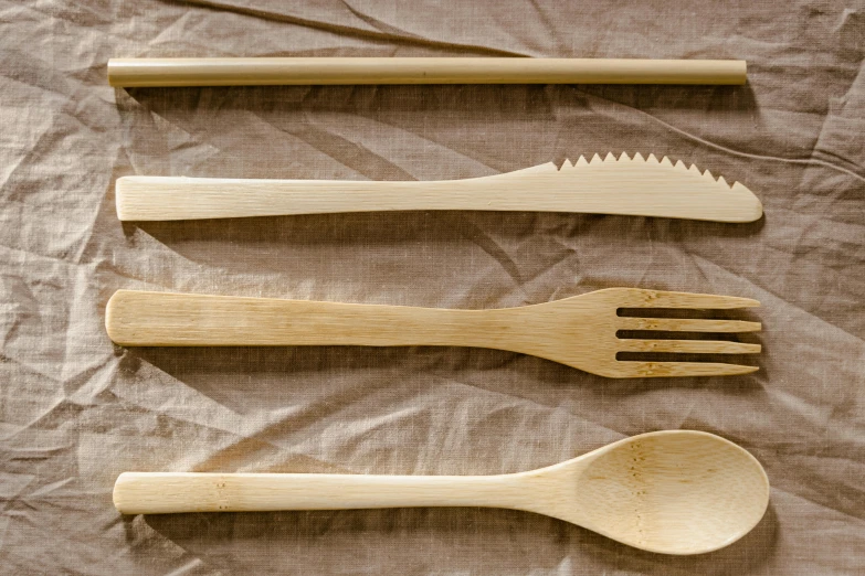 a group of four wooden utensils and spoons