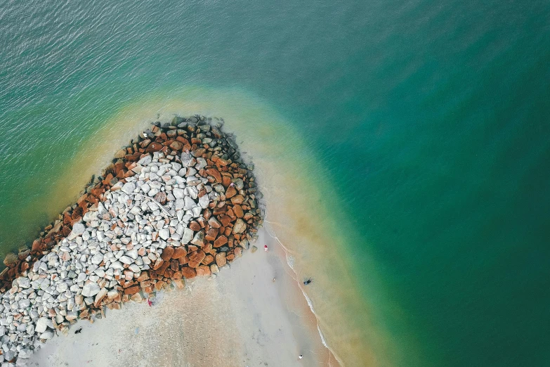 a heart - shaped formation created by rocks is shown in the water