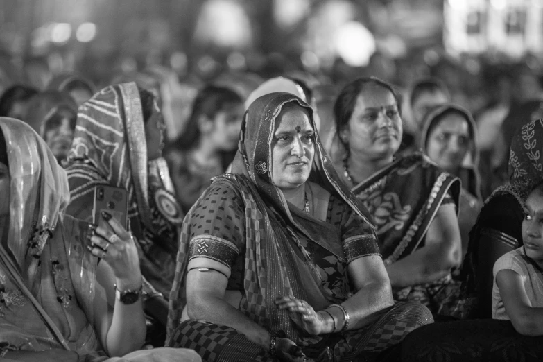 people in indian garb sitting down at the festival