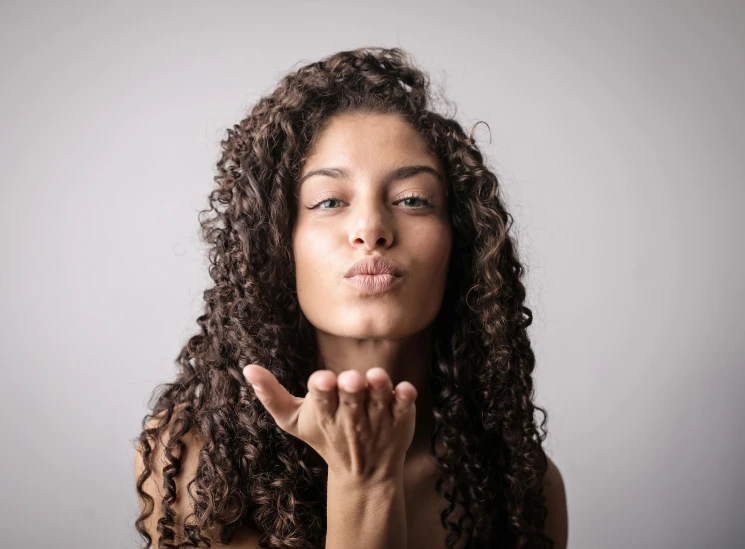 a woman with her hands together, saying it's ok to stop