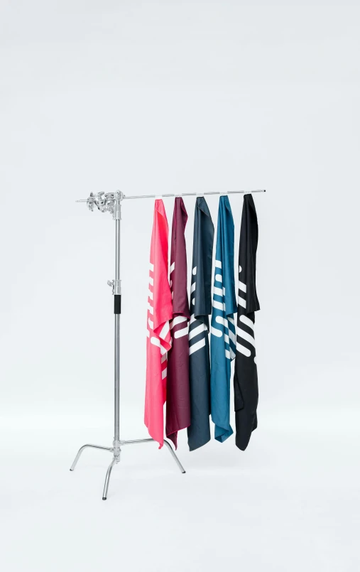 three towels hanging on a metal rack with the same color