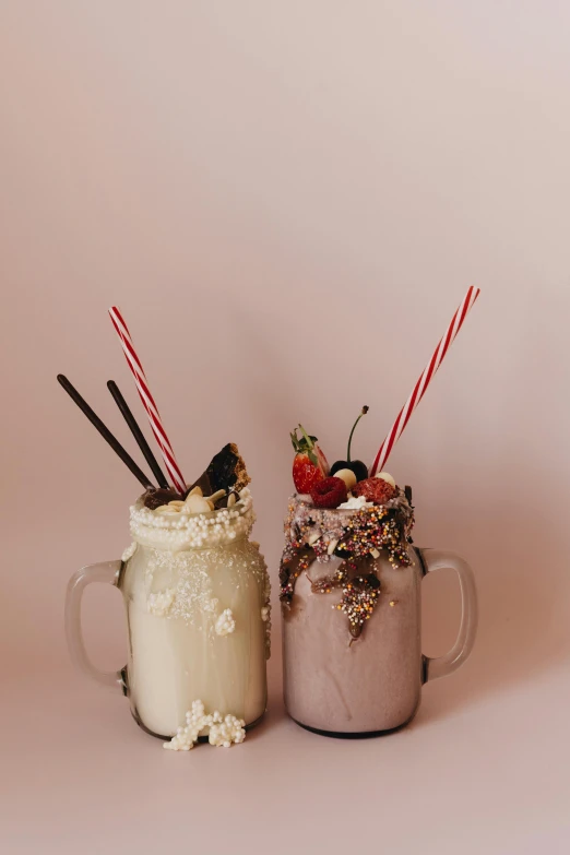 a couple of mugs sitting next to each other with strawberries on top